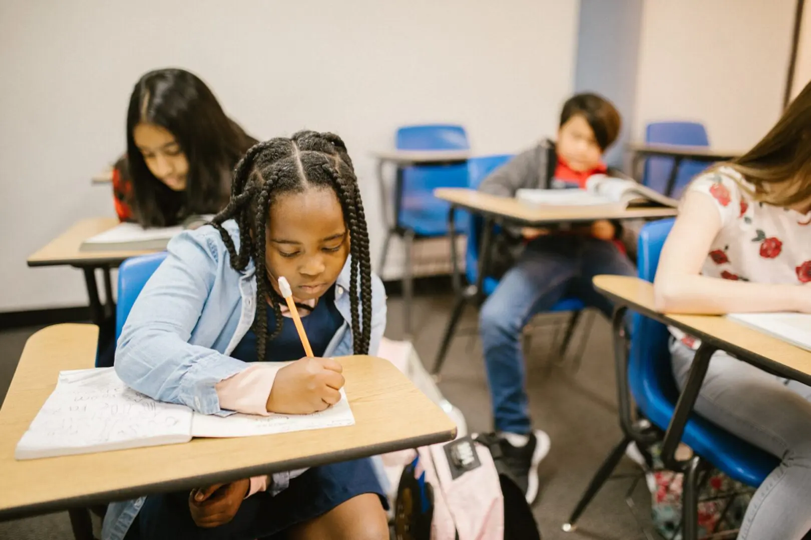 A group of children sitting at desks in a classroom.